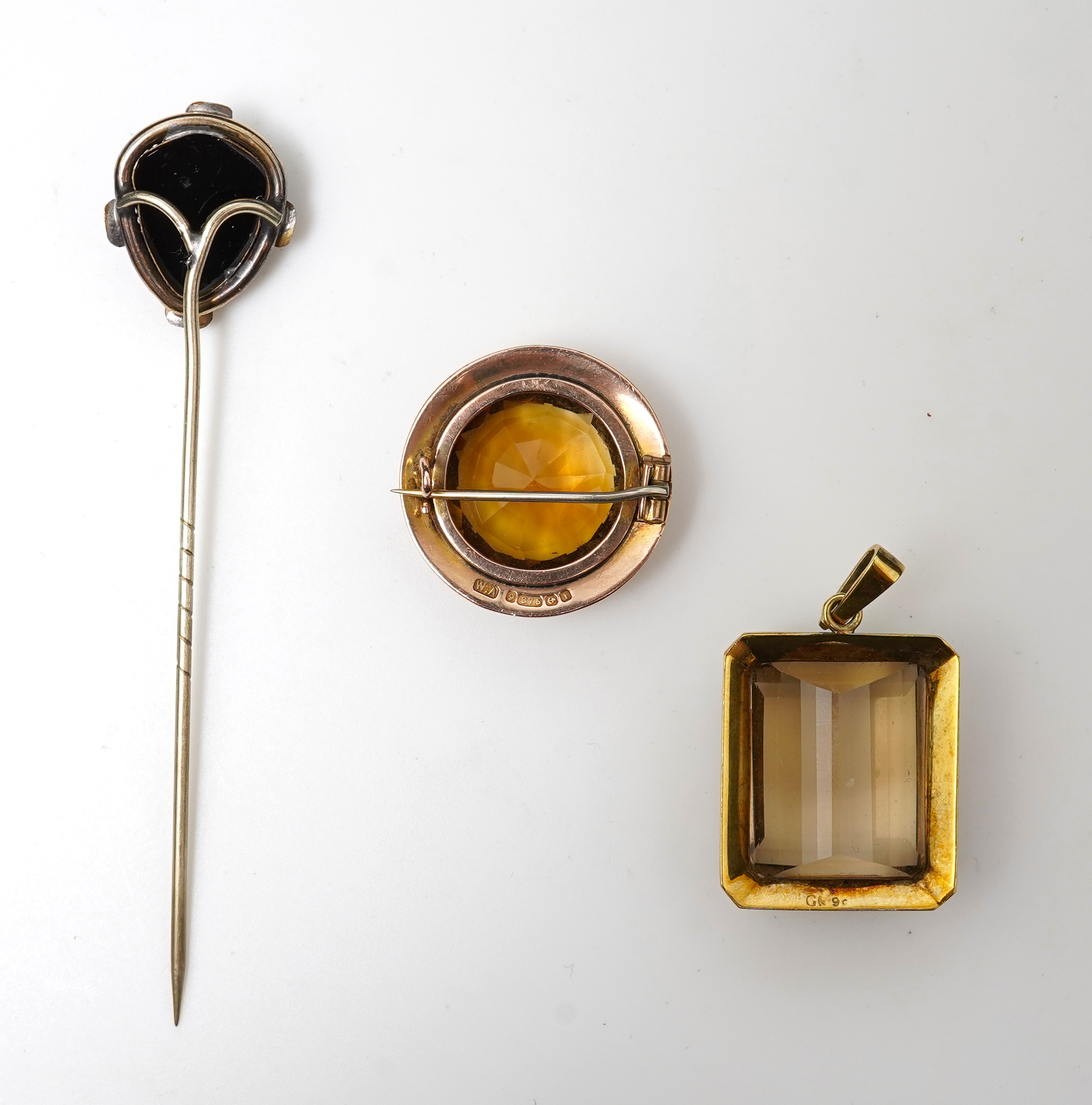 A citrine brooch and pendant, and onyx stickpin